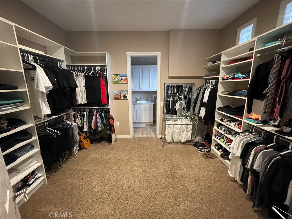 25452 Edna Road Murrieta, CA 92562 - Photo 28 of 70 a view of walk in closet with clothes and shoes