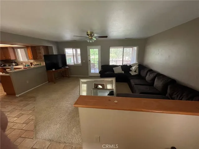 a living room with furniture and a chandelier