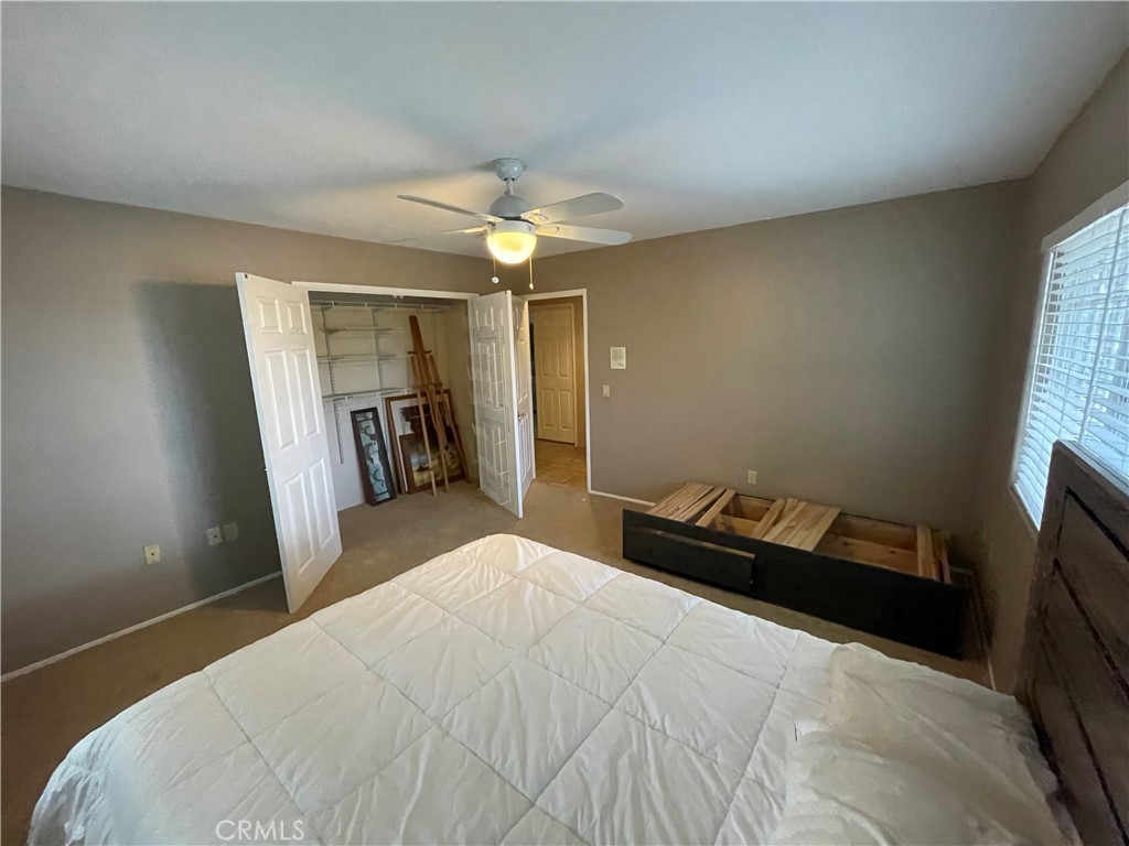 25452 Edna Road Murrieta, CA 92562 - Photo 35 of 70 a bedroom with a bed and a chandelier