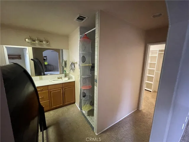 a view of a big yard with plants and large trees