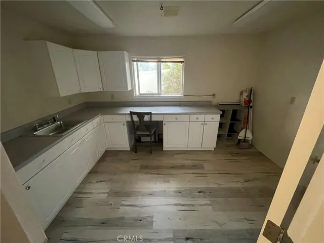 a view of dirt yard with a large tree