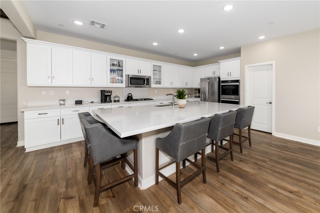 1740 Boysen Way Beaumont, CA 92223 - Photo 13 of 49 a kitchen with kitchen island a dining table and chairs