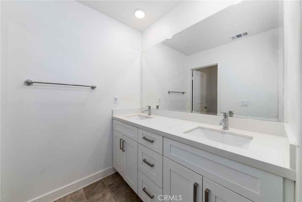 1740 Boysen Way Beaumont, CA 92223 - Photo 26 of 49 a bathroom with a double vanity sink and mirror