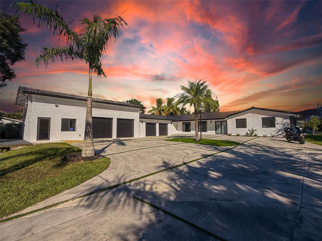 5790 Melaleuca Road Southwest Ranches, FL 33330 - Photo 1 of 44 a front view of a house with a garden and yard