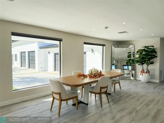 a dining room with furniture and wooden floor