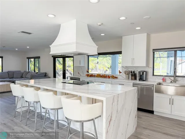 a large kitchen with a table and chairs