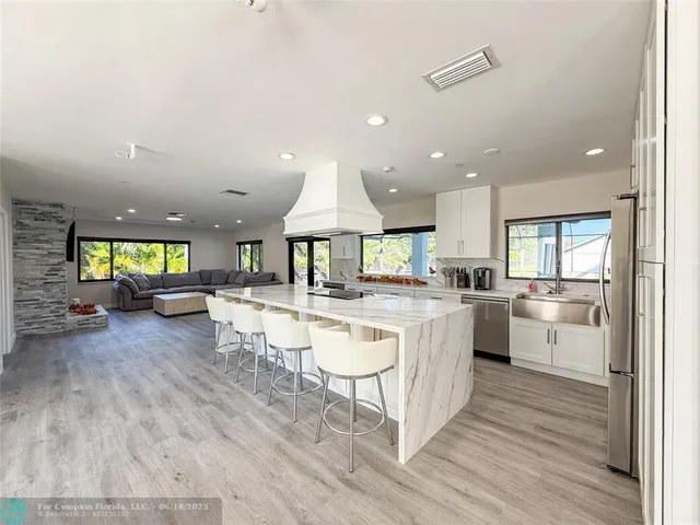a kitchen with a sink cabinets and wooden floor