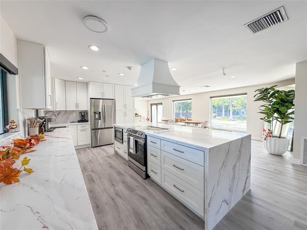 5790 Melaleuca Road Southwest Ranches, FL 33330 - Photo 20 of 44 a large kitchen with cabinets and wooden floor