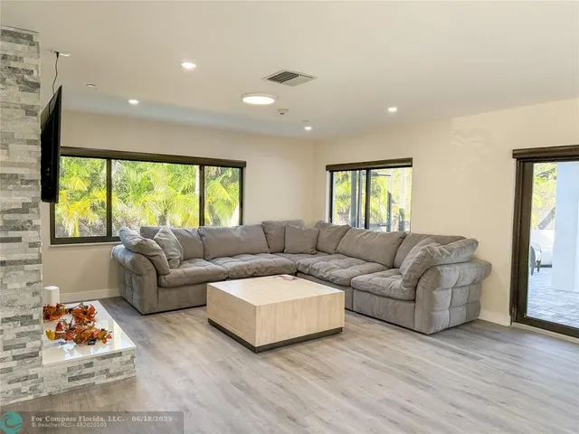 a living room with furniture and a large window