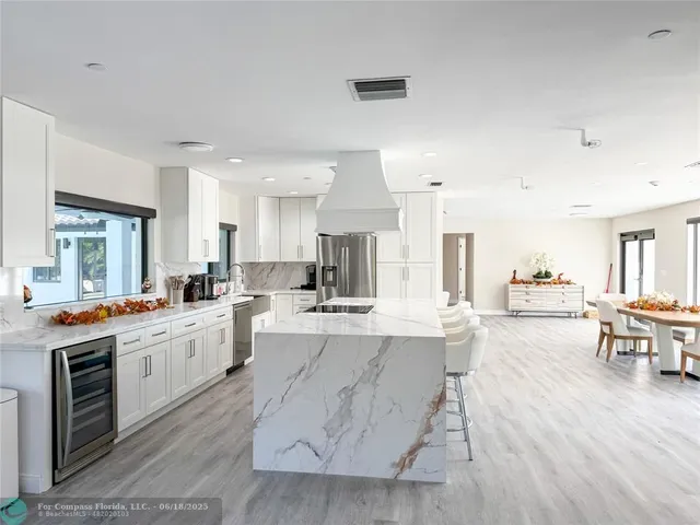 a large kitchen with a table and chairs in it