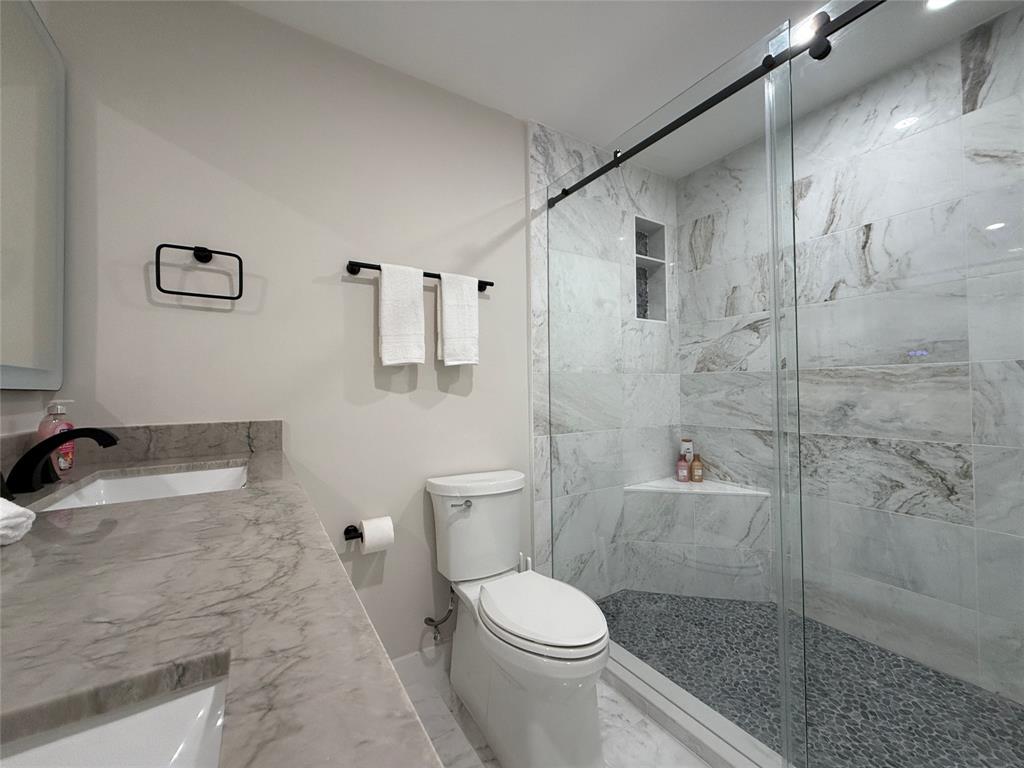 5790 Melaleuca Road Southwest Ranches, FL 33330 - Photo 24 of 44 a bathroom with a granite countertop bathtub shower sink mirror and toilet