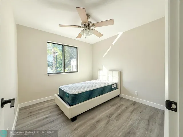 a spacious bedroom with a bed and window
