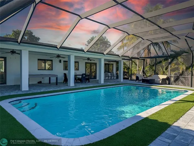 a view of a backyard with a swimming pool
