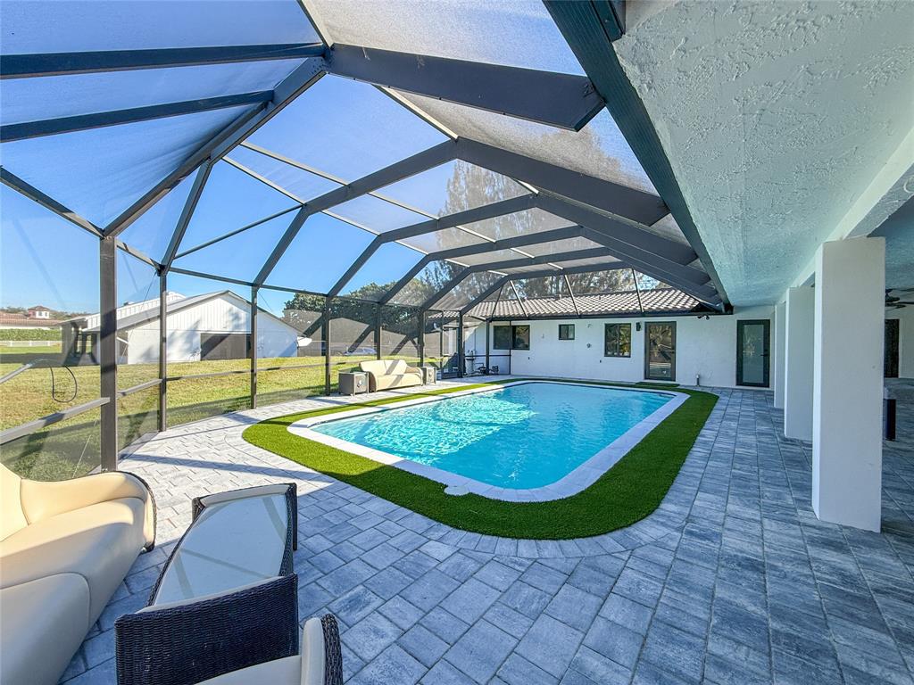 5790 Melaleuca Road Southwest Ranches, FL 33330 - Photo 33 of 44 a view of a swimming pool with a patio