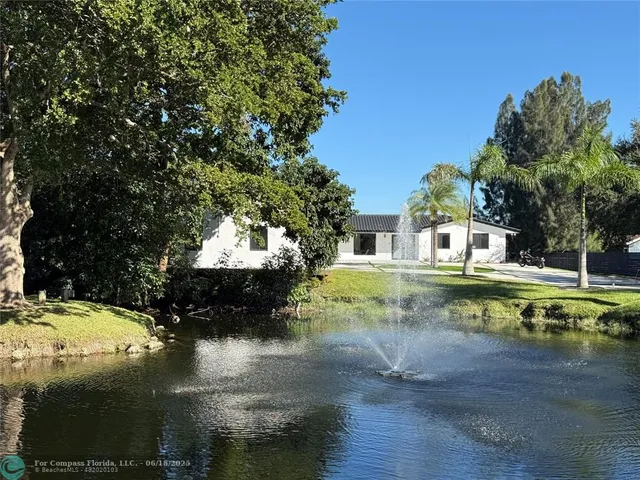 a view of a swimming pool with a yard