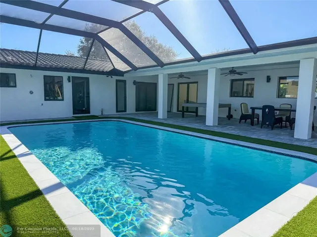 a view of a backyard with swimming pool