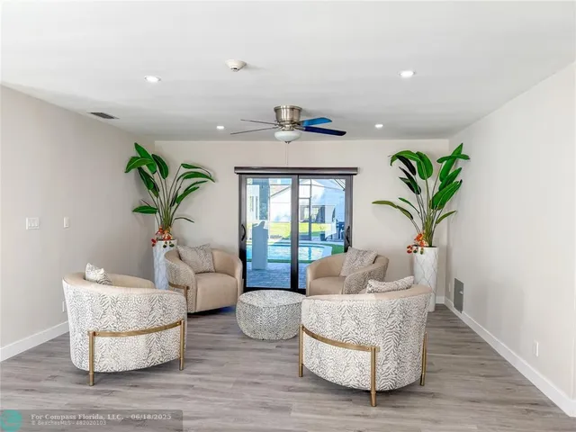 a living room with furniture and a potted plant