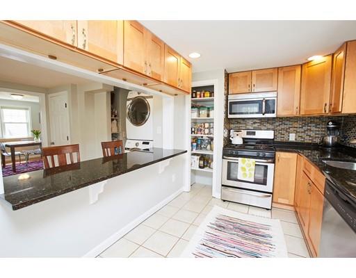 26 Hallron Street Boston, MA 02136 - Photo 11 of 21 a large white kitchen with granite countertop a sink and cabinets