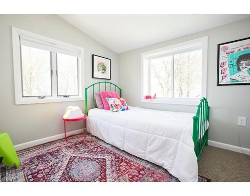 26 Hallron Street Boston, MA 02136 - Photo 19 of 21 a bed sitting in a bedroom next to a window