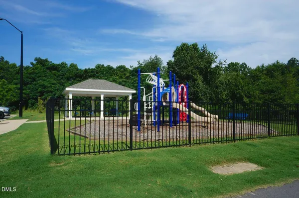 a view of a patio with dining table and chairs with couches and wooden fence