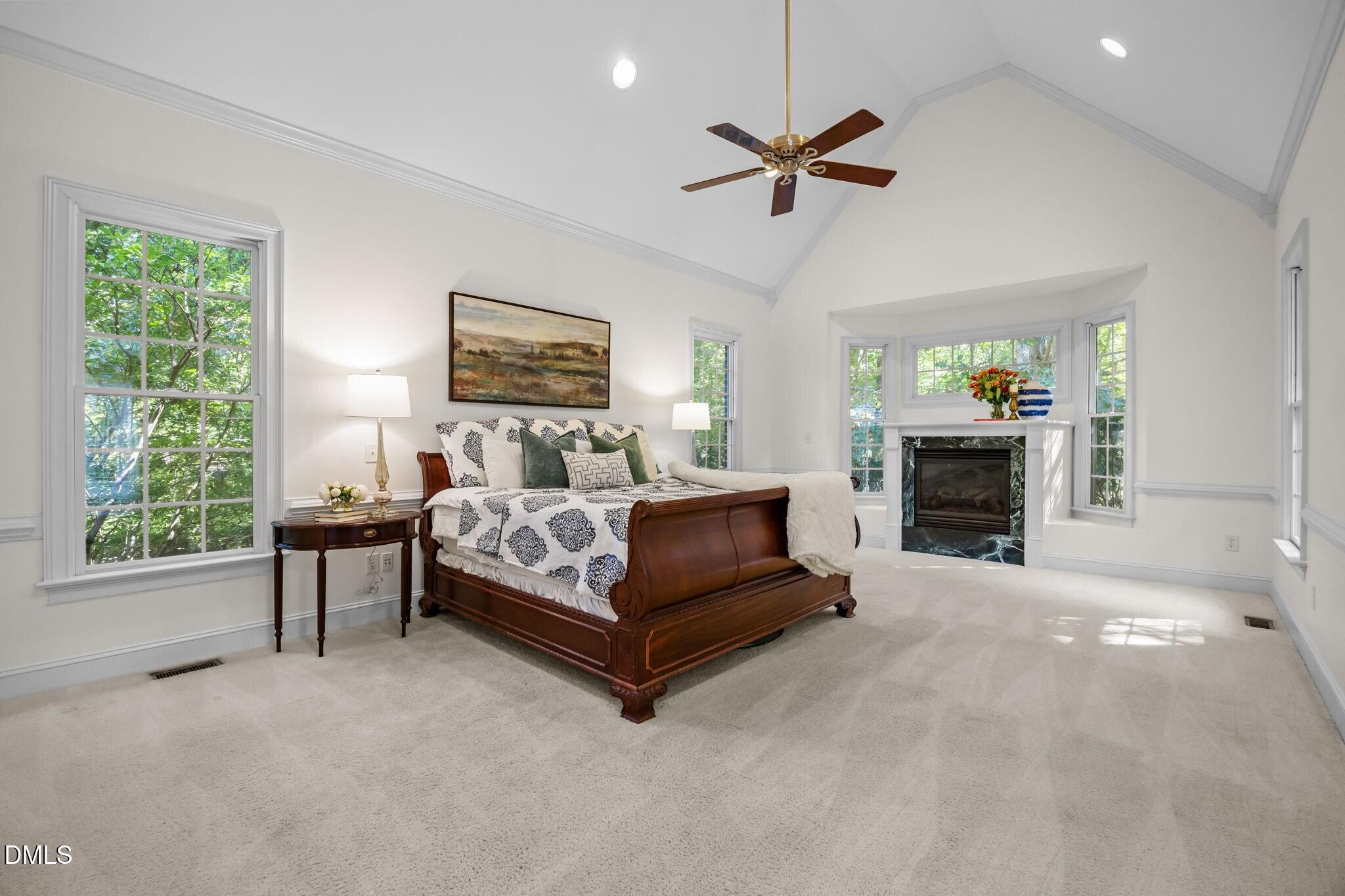 3901 Orchard Point Court Apex, NC 27539 - Photo 14 of 53 a spacious bedroom with a bed and a fireplace