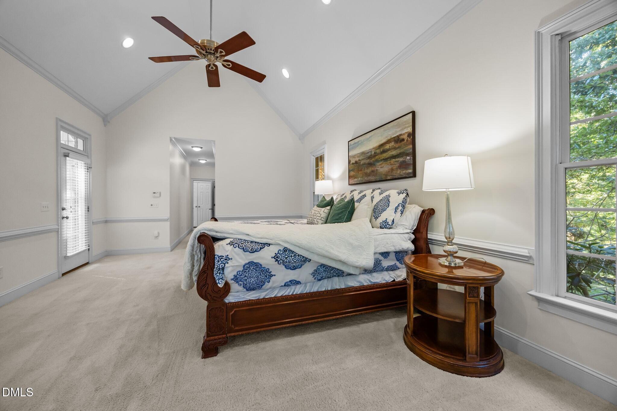 3901 Orchard Point Court Apex, NC 27539 - Photo 15 of 53 a bedroom with a bed and a lamp