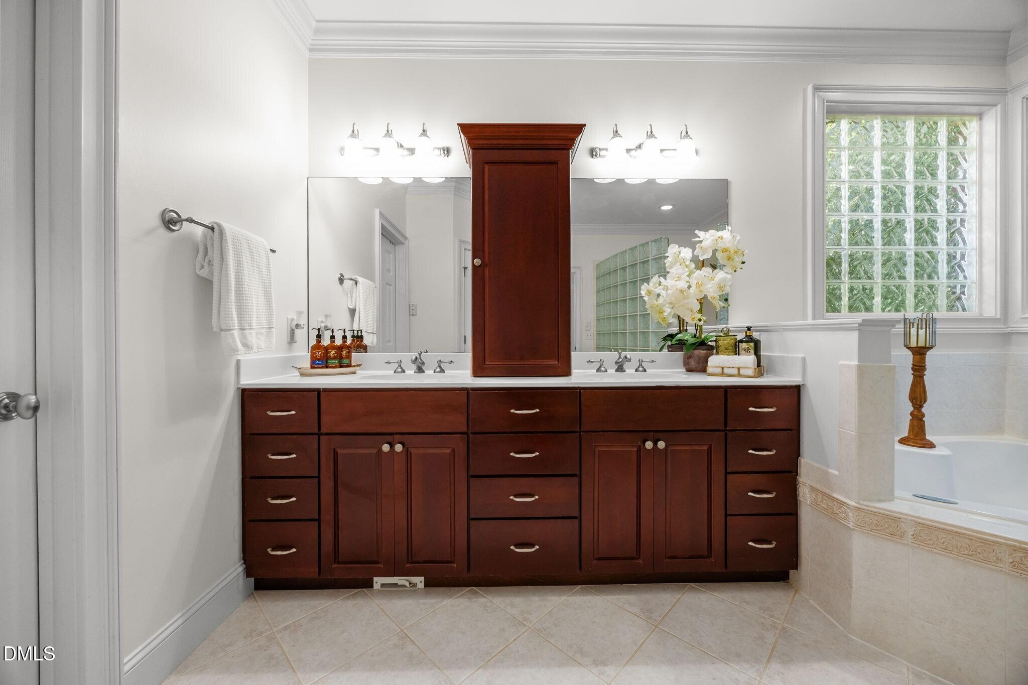 3901 Orchard Point Court Apex, NC 27539 - Photo 16 of 53 a bathroom with a vanity and a sink