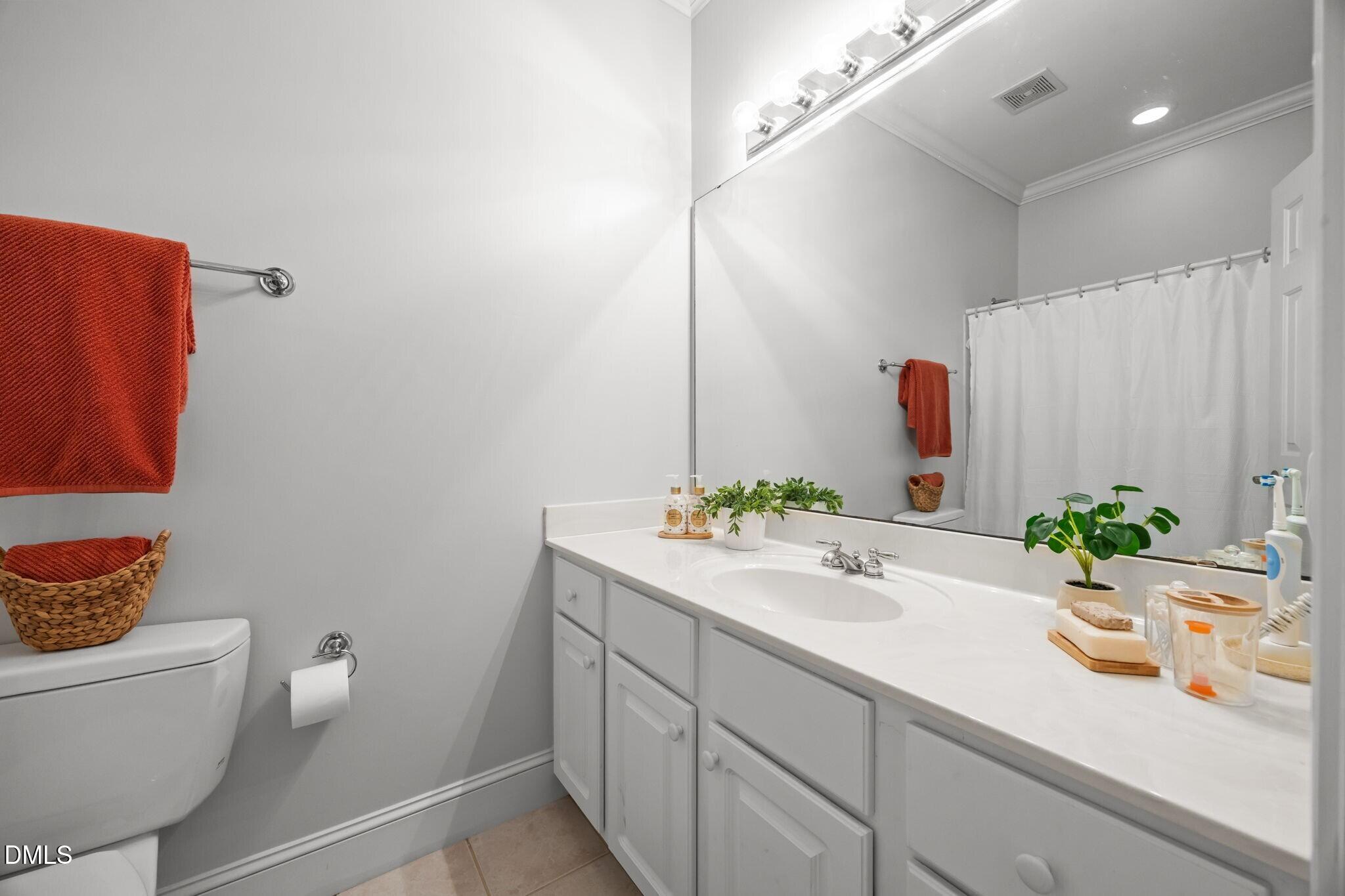 3901 Orchard Point Court Apex, NC 27539 - Photo 32 of 53 a bathroom with a granite countertop sink mirror and toilet