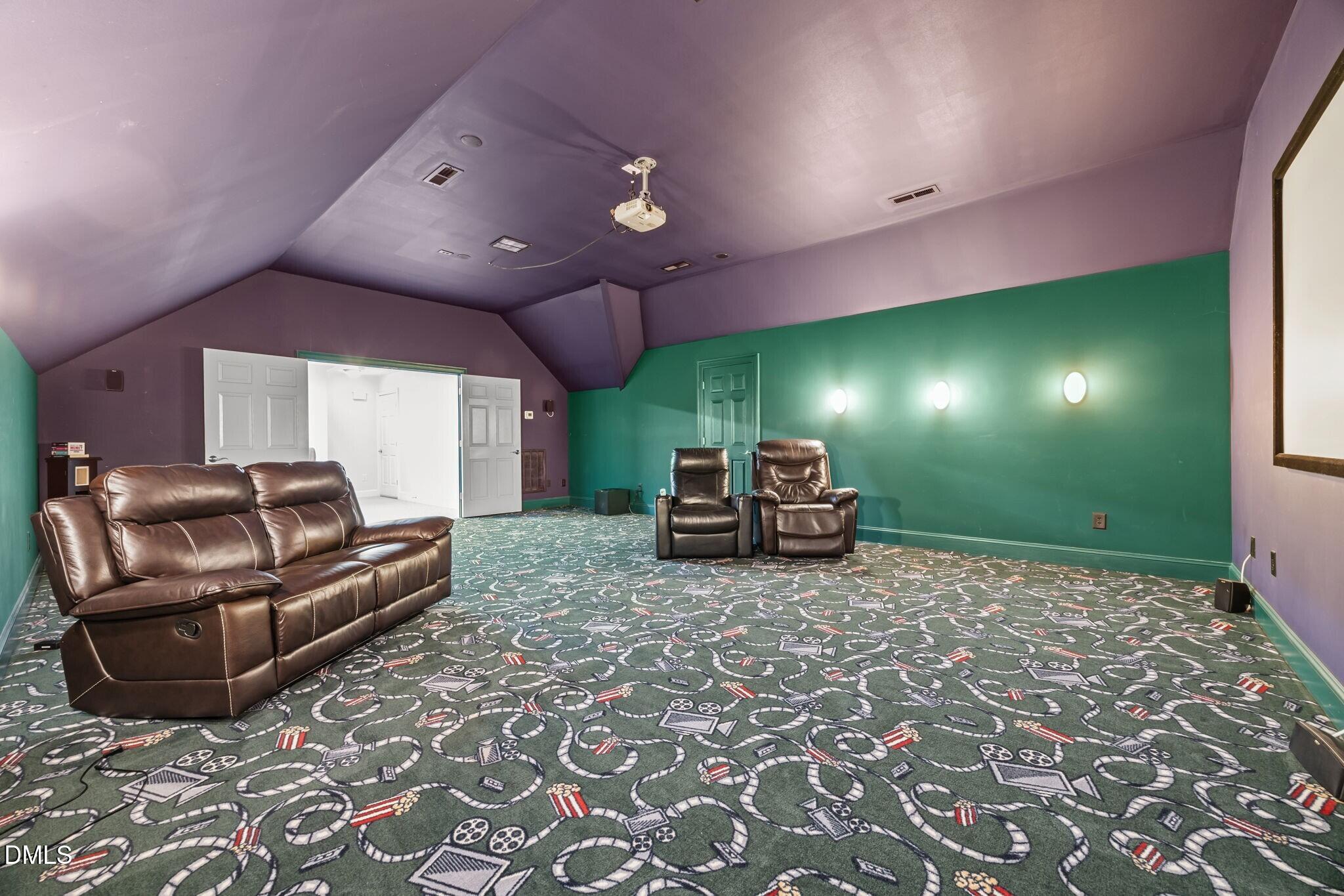 3901 Orchard Point Court Apex, NC 27539 - Photo 40 of 53 a living room with furniture and a flat screen tv