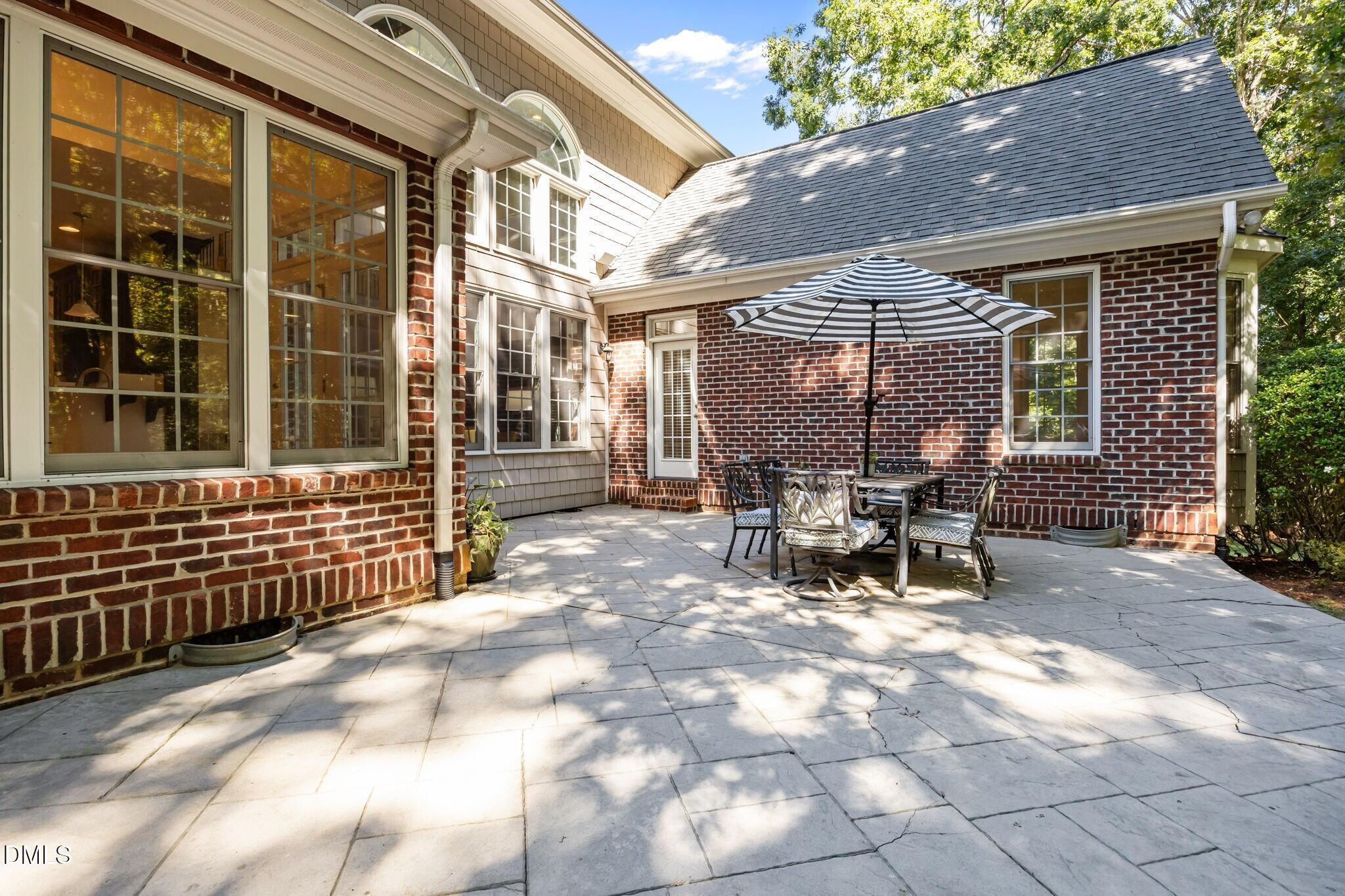 3901 Orchard Point Court Apex, NC 27539 - Photo 44 of 53 a view of a patio with table and chairs and potted plants