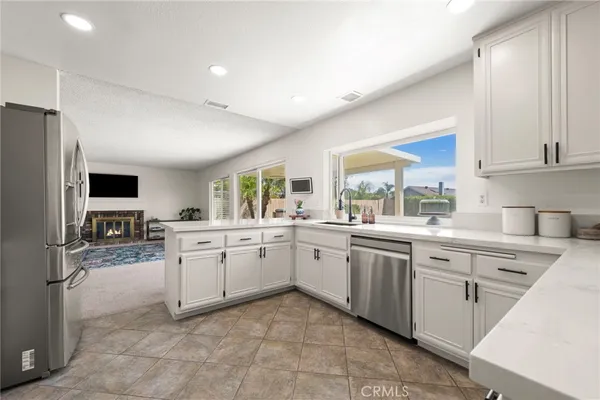 a kitchen with cabinets stainless steel appliances and a counter space