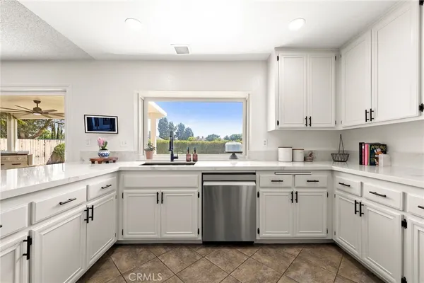 a kitchen with appliances cabinets and a counter top space