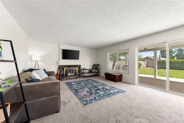 a living room with furniture and kitchen view