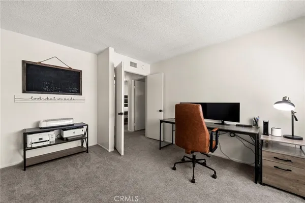 a spacious bedroom with a bed a fireplace and a large window