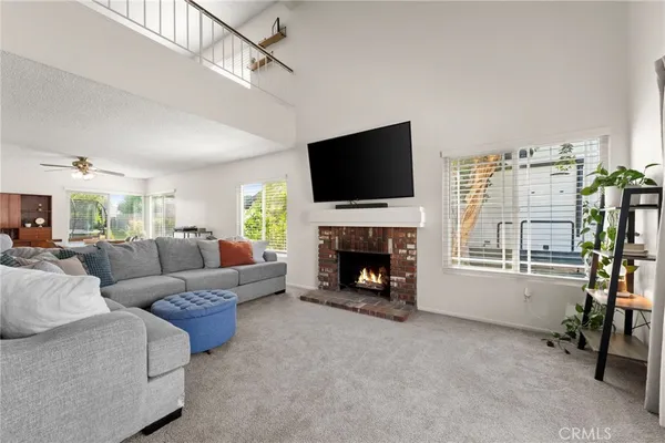 a view of a livingroom with furniture and a window