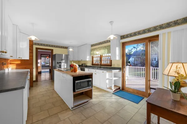 a living room with furniture and a open kitchen view