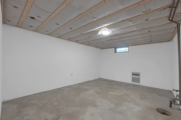 a view of empty room with wooden ceiling