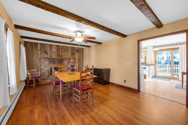 a dining room with furniture and wooden floor