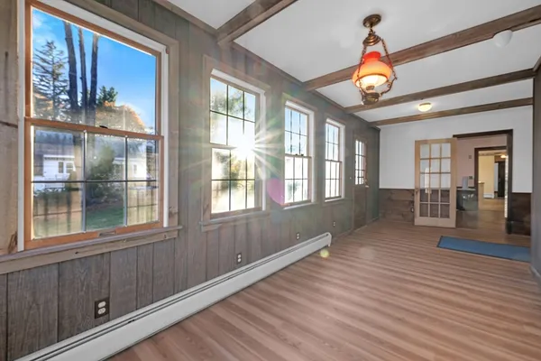 a view of an entryway with wooden floor and windows