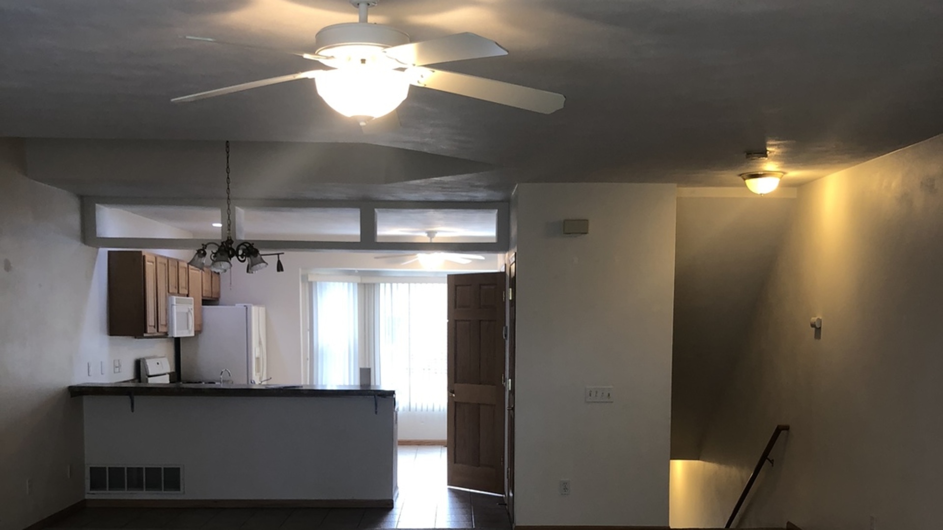 6032 Park Ridge Road, Unit 6032 Loves Park, IL 61111 - Photo 2 of 13 a view of a room with a chandelier fan and wooden floor