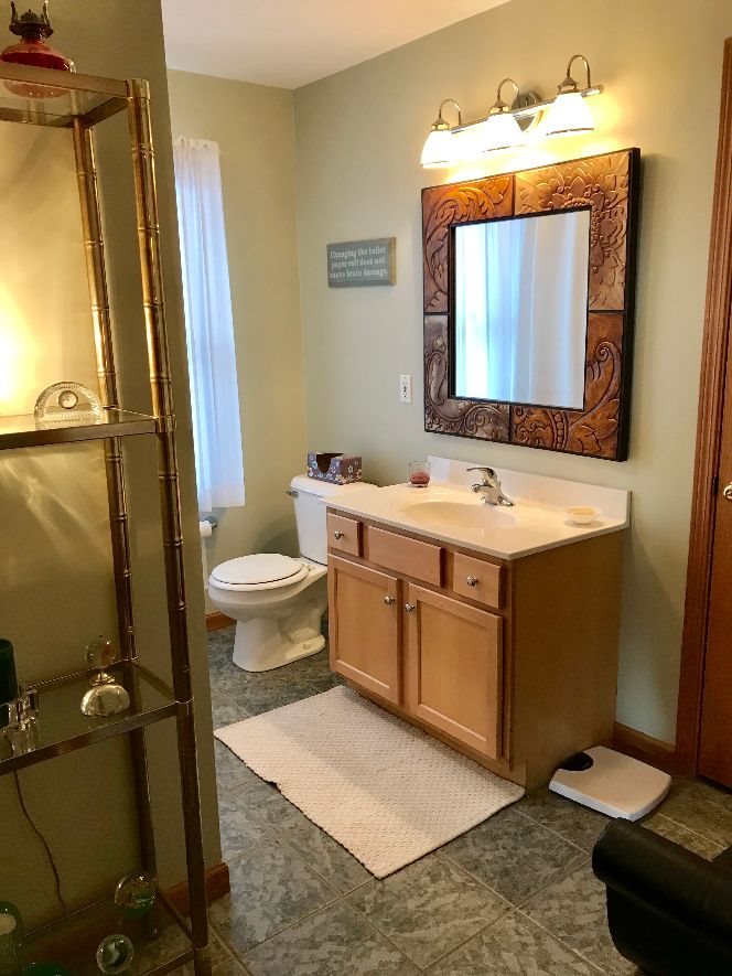 9289 North Barker Road Byron, IL 61010 - Photo 17 of 25 a bathroom with a sink toilet and mirror