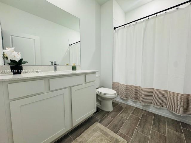 19552 Whispering Creek Road, Unit 1 West Palm Beach, FL 33470 - Photo 11 of 16 a bathroom with a sink a toilet and a mirror