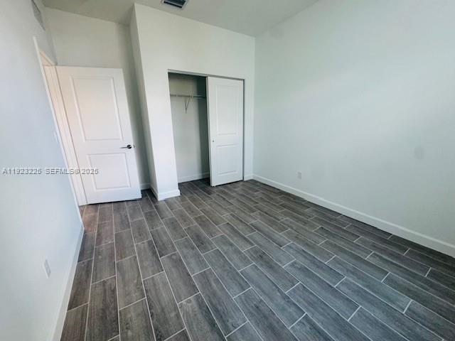 19552 Whispering Creek Road, Unit 1 West Palm Beach, FL 33470 - Photo 14 of 16 a view of a room with wooden floor and white doors