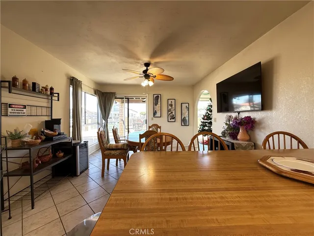 a living room with furniture pool table and flat screen tv