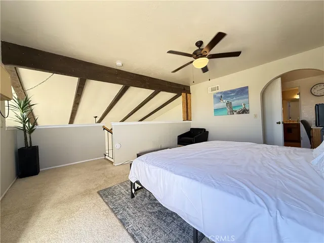 a bedroom with a bed and a large window
