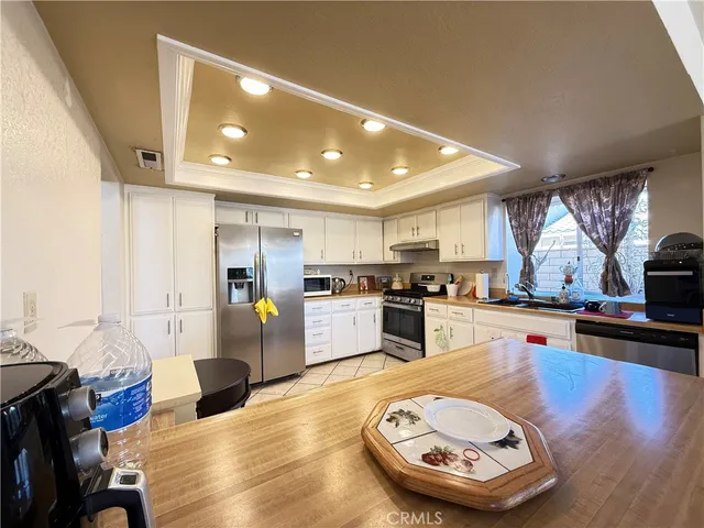 a kitchen with stainless steel appliances granite countertop a stove and a refrigerator