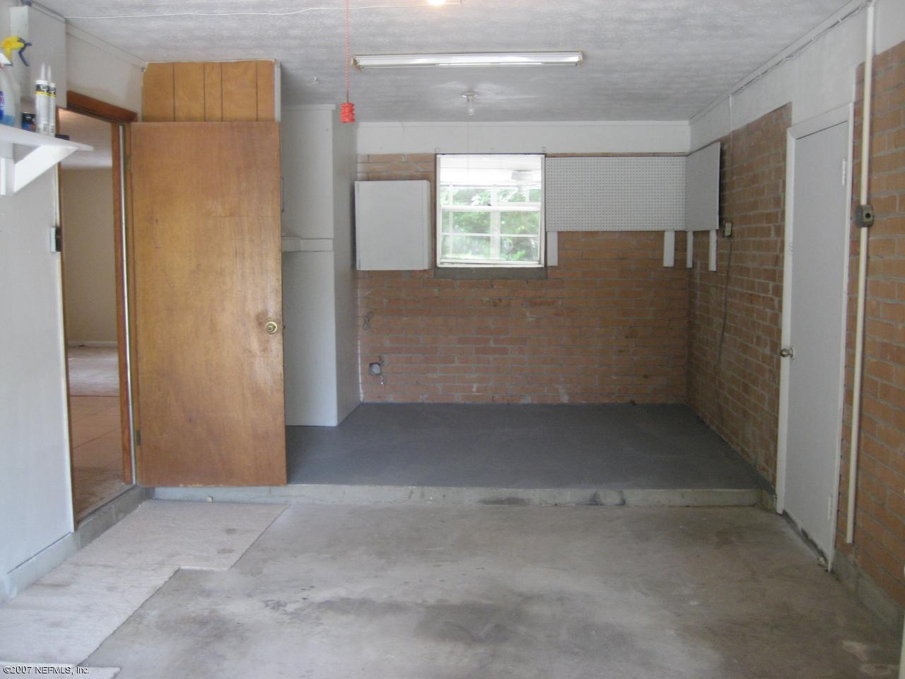 2613 Tulsa Road North Jacksonville, FL 32218 - Photo 3 of 5 a view of an empty room with windows and refrigerator
