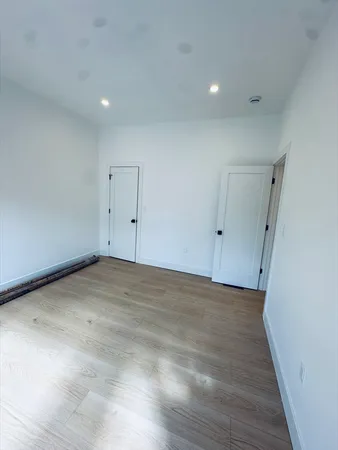 a bathroom with a tub a sink and a mirror