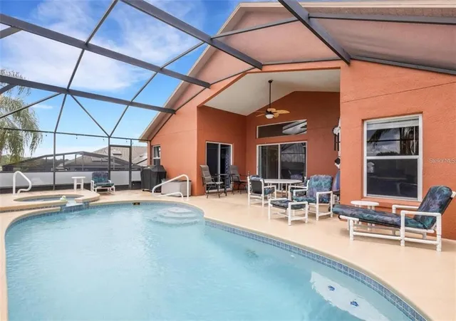 a view of a swimming pool with outdoor seating