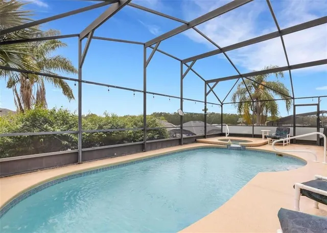 a view of a swimming pool with a lounge chair
